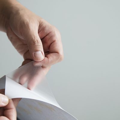 Man installing sticker film to mirror window house interior decoration